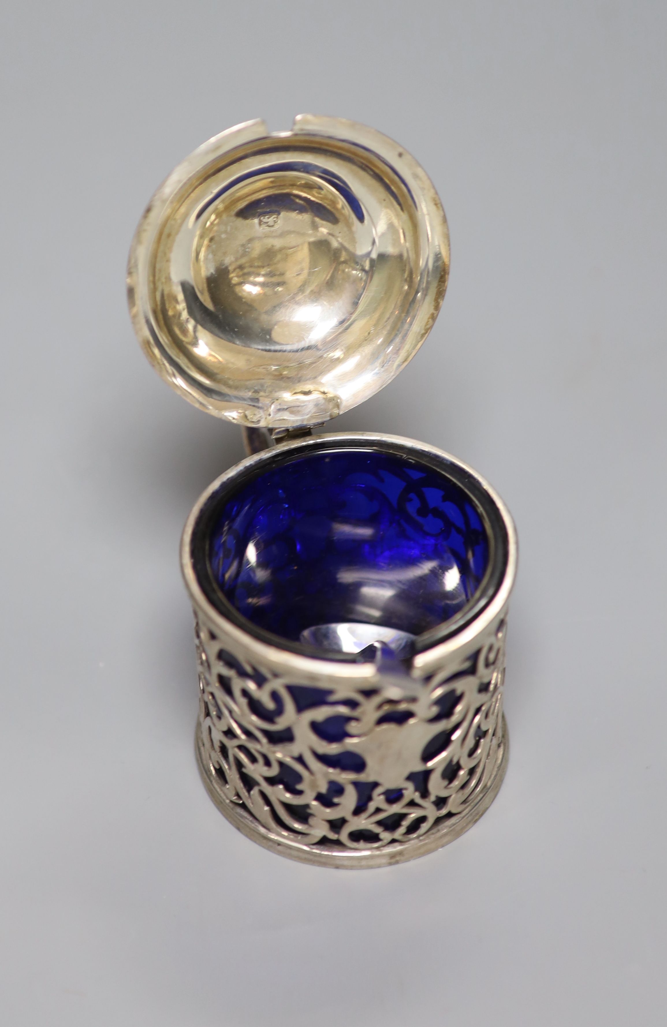 A George III pierced silver drum mustard, London, 1767, (a.f.) with blue glass liner